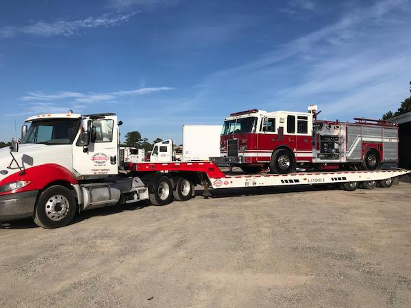 Truck transporting a fire truck